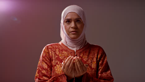 Studio-Head-And-Shoulders-Portrait-Of-Muslim-Woman-Wearing-Hijab-Praying-9